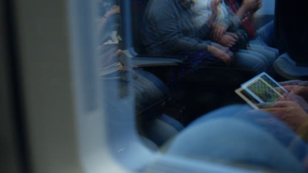 Reflection of rush hour commuters bored on train — Stock Video