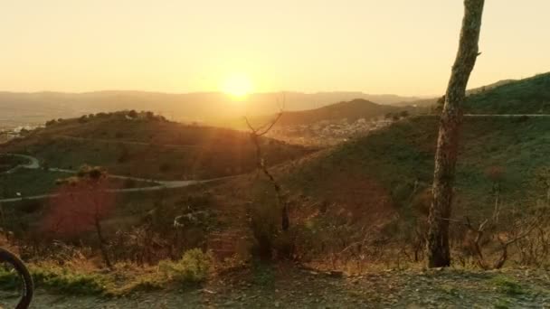 Drone footage of woman cyclist in sunset on bike — Stock Video