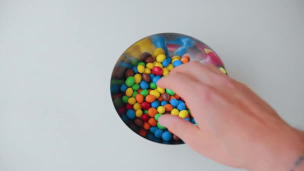 Les amis prennent des boules de bonbons colorées du bol — Video