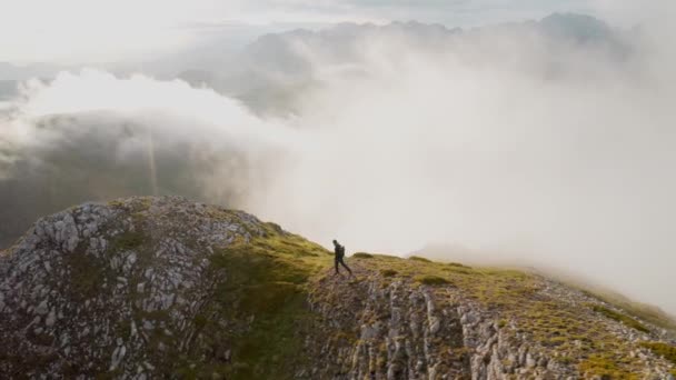 Drone shot of hiker on mountain cloudy top — Stock Video