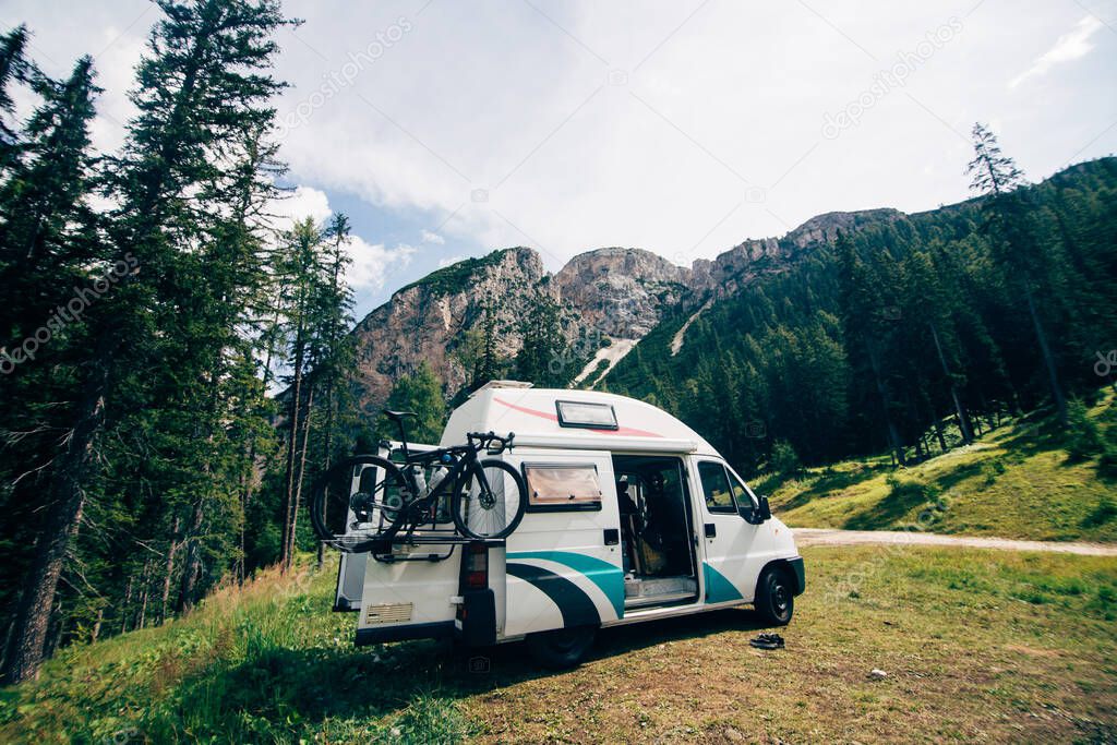 Cute camper van RV in wild camping spot in nature