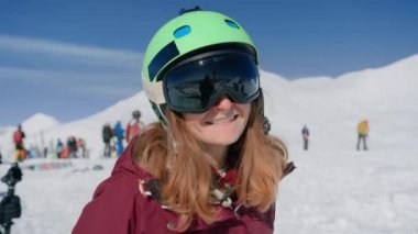 Kayak gözlüklü mutlu kadın kameraya güler.