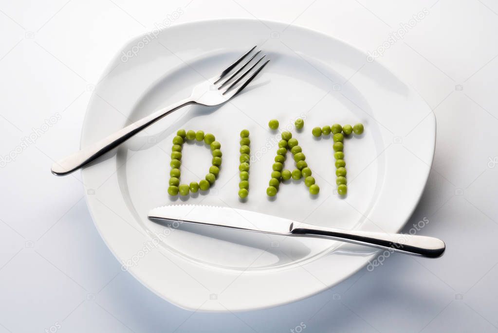 Peas forming the word diet on a plate
