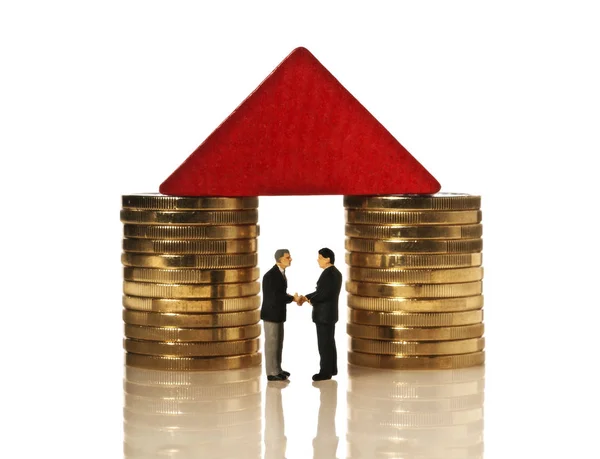 Two businessmen shaking hands under a red roof — Stock Photo, Image