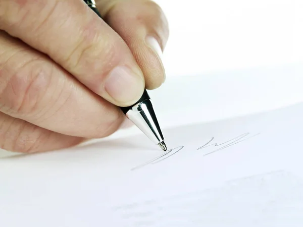 Close-up of a hand while signing — Stock Photo, Image
