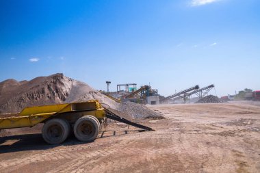 Ezici makineler, koni tipi kaya öğütücü, taş ocağında ezilmiş granit çakıl taşlarını taşıma. Ezilmiş taş ve çakıl işleme tesisi. Madencilik ve Madencilik ekipmanları.