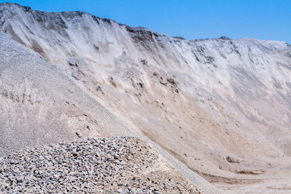 Gravel stone dumps in a quarry open pit mining. Processing plant for crushed stone and gravel. Mining and Quarry mining material.
