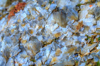 The mica sheets and quartz silicate minerals. Bare geological rock in soft sludge clay rocks. Macro lens shot. clipart