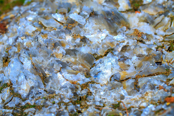 The mica sheets and quartz silicate minerals. Bare geological rock in soft sludge clay rocks. Macro lens shot.