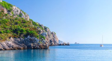 Güzel yaz panoramik deniz manzarası. Güneş ışığında berrak masmavi su ile defne deniz görünüme uçurumdan. Tekneler ve yatlar liman. Akdeniz, Avrupa'da bir yerde.
