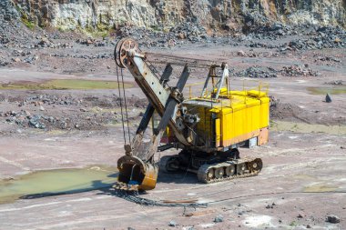 Bir büyük Zincirli ekskavatör Granit taş ocağı açık Ocak madenciliği. İşlem üretim taş ve çakıl. Taş ocağı madencilik ekipmanları.