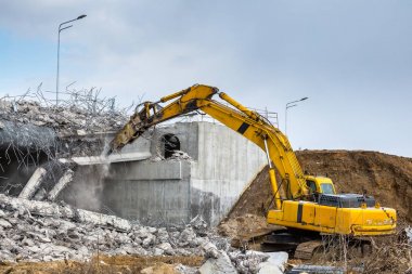 Professional demolition of reinforced concrete structures using  clipart