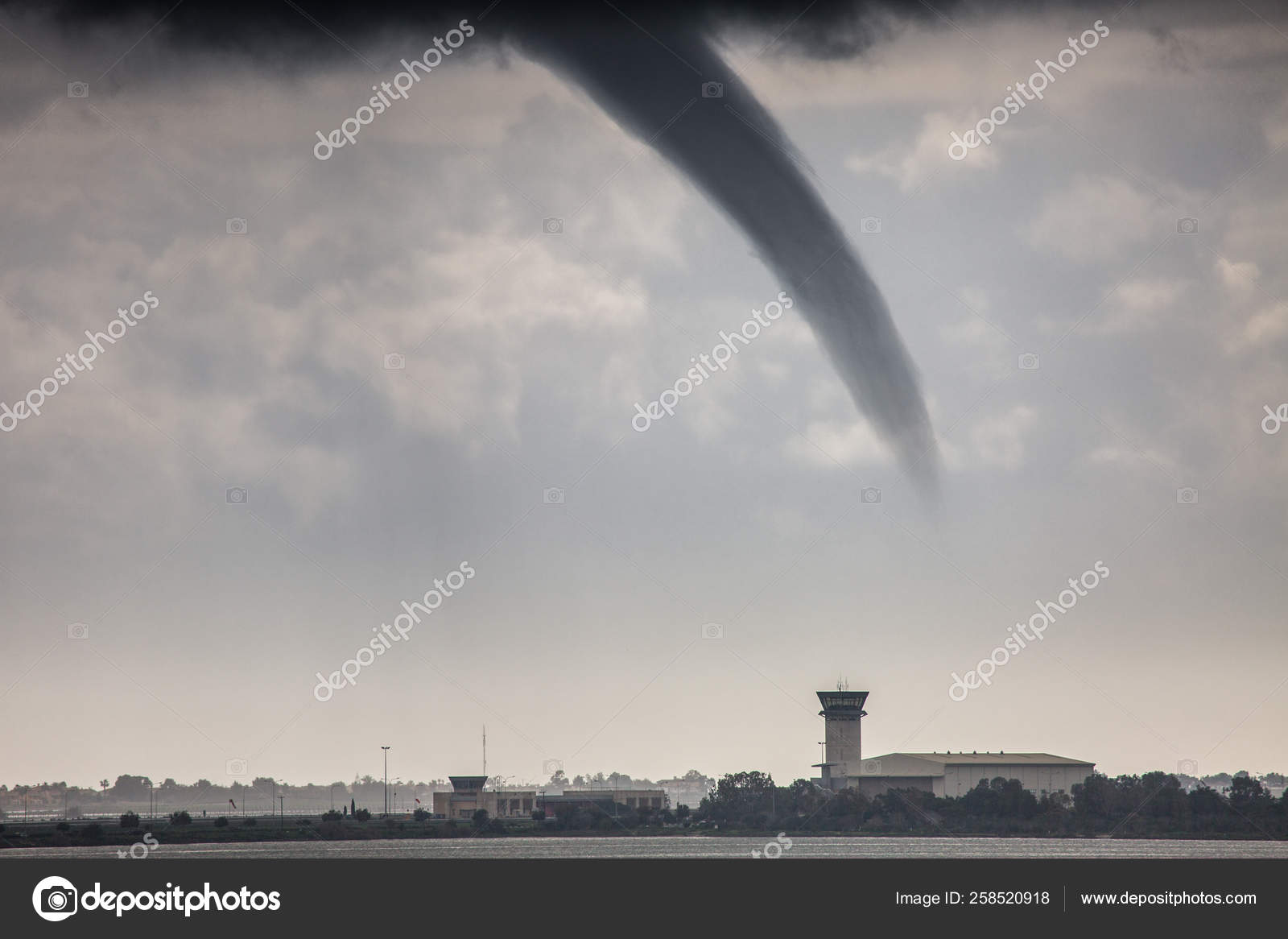 A rope tornado above the runway and airport traffic control towe Stock Photo by ©Sodel_Vladyslav