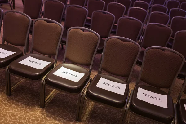 Brown chairs the conference hall before the event. First row for