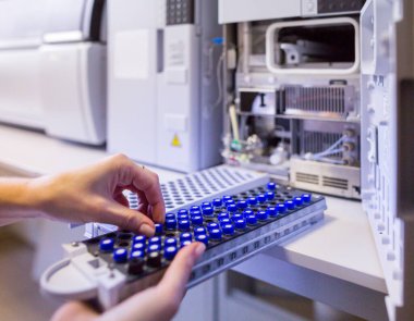 The laboratory scientist prepares samples for download to High-performance Liquid Chromatograph Mass Spectrometr. clipart