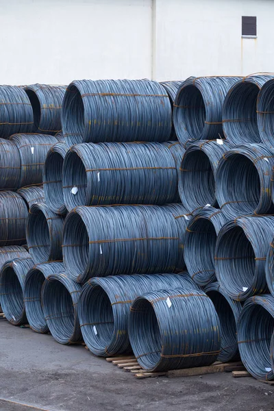 Steel low carbon wire rod, hot rolled steel drawing wire twelve millimeters or half an inch in diameter in coils. Freight transportation of heavy industry products by seaports. Export-import activity.