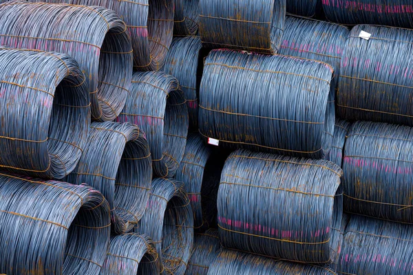 Steel low carbon wire rod, hot rolled steel drawing wire twelve millimeters or half an inch in diameter in coils. Freight transportation of heavy industry products by seaports. Export-import activity.