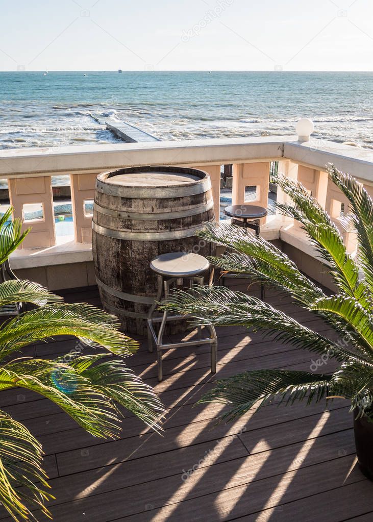 Barrel and stools in a cafe on the beach of the black sea Russia Sochi