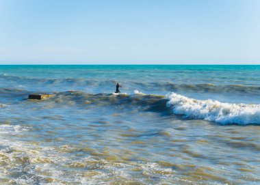 Karadeniz Soçi'de sörf yaparken siyah dalgıç kıyafetli bir adam 05.12.201