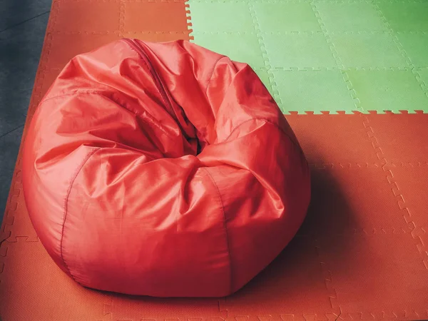 Красная сумка для круглого стула на красном зеленом покрытии — стоковое фото