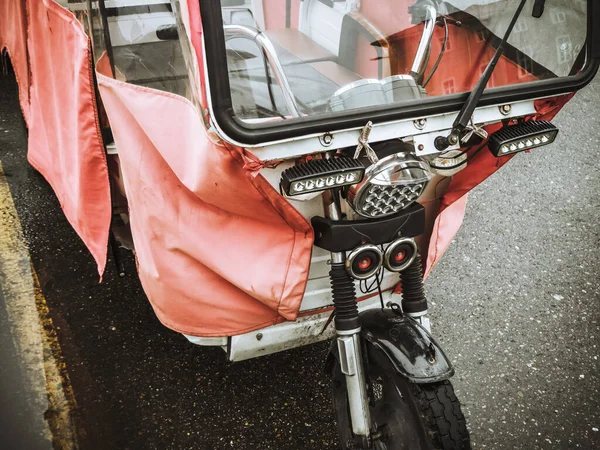 Närbild foto av ett fragment av en gående motorcykel täckt med en transparent röd huv — Stockfoto