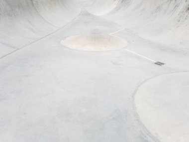 Ortasında koni engeli olan boş beton kaykay parkı. Tam ekran fotoğrafı