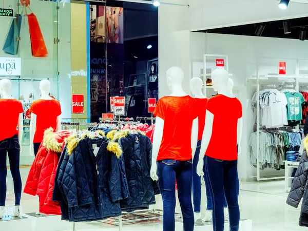 Sochi, Rusya - 14 Aralık 2019. Mağazadaki kot ve kırmızı tişörtlü mankenler, kış ceketlerinin ve diğer mankenlerin arka planına karşı.