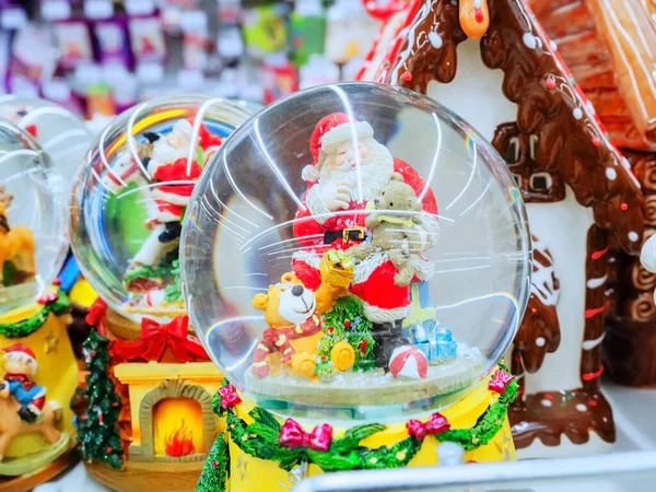 Transparent ball with santa claus and teddy bears inside it — Stock Photo, Image