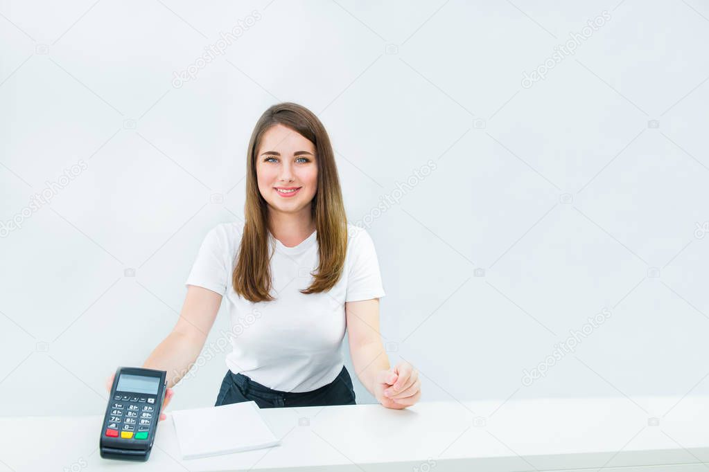 Administrative manager or seller holding payment terminal at reception desk. Contactless payment with nfc technology at shop, clinic, hotel. Mobile payment PayPass. Copy space. White background