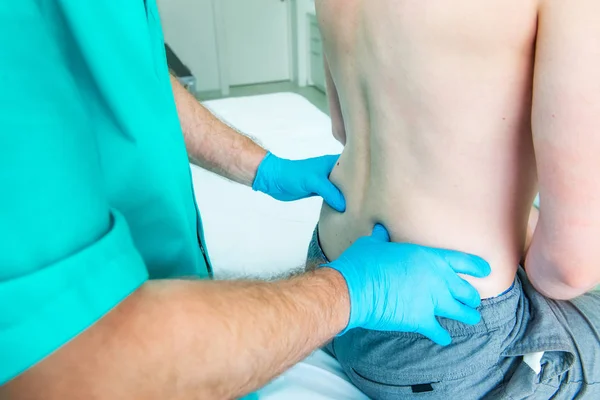 Close up Médico neurologista masculino diagnostica a coluna lombar do paciente masculino na clínica médica. Exame físico neurológico. Osteopatia, quiropraxia, fisioterapia — Fotografia de Stock
