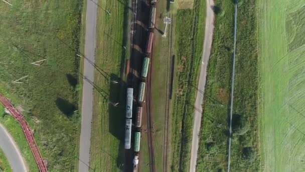 Logistics in manufacture, aerial view of freight trains laden with granite and marble, moving train, industrial landscape. — Stock Video