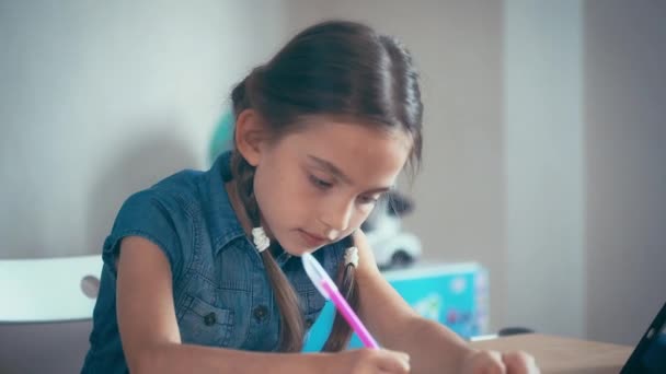 Schulmädchen, die Hausaufgaben, schreibt in einem Notizbuch, Müdigkeit aus den Lektionen. — Stockvideo