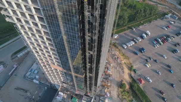 Construction, aerial view of building glass skyscraper, business center view from height, reflections in glass, sunlight. — Stock Video