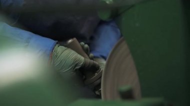 Üretim saatı, ana makine üzerinde çelik parçalar biler.