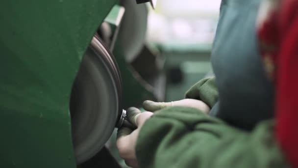 Виробництво годинників, майстер подрібнює сталеві деталі на машині . — стокове відео