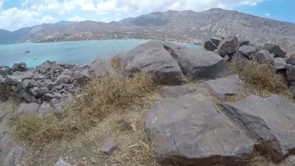 Fuß Schritte von Wanderern Wandern im Freien. Zu Fuß auf felsigem Terrain antike griechische Ruinen pov spinalonga Reisekonzept — Stockvideo