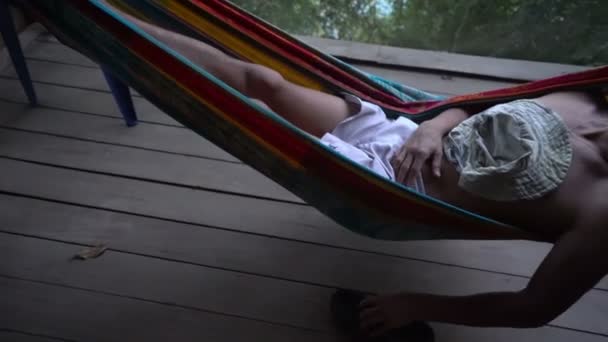 Man in hammock laying alone abandoned and getting mad distracted, loneliness mentally ill — Stock Video
