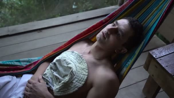 Man in hammock laying alone abandoned and getting mad distracted, loneliness mentally ill — Stock Video