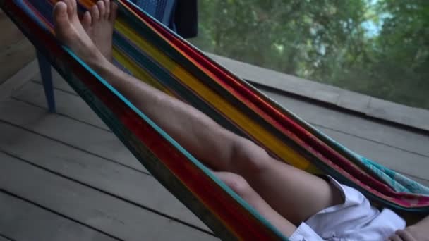 Man in hammock laying alone abandoned and getting mad distracted, loneliness mentally ill — Stock Video