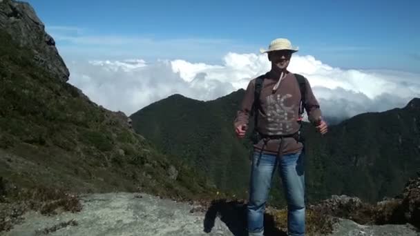 Recuerdos clip, el hombre en la cima de las montañas por encima de las nubes sentirse bien — Vídeos de Stock