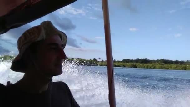 Man travelling by sea on boat, water drops falling on him. Extreme adventure, summer holidays — Stock Video