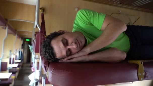 Мужчина спит в поезде. Уставший рабочий студент спит после работы, тяжелого дня, болезни, усталости — стоковое видео
