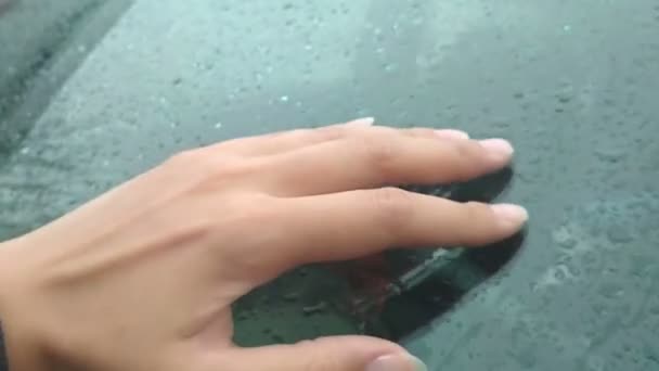 Mano femenina tocando vidrio con gotas de lluvia. sensaciones táctiles — Vídeo de stock