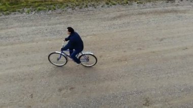 cycling road bike, bycicle rider from top, aerial view, shot from above, man cyclist on empty road