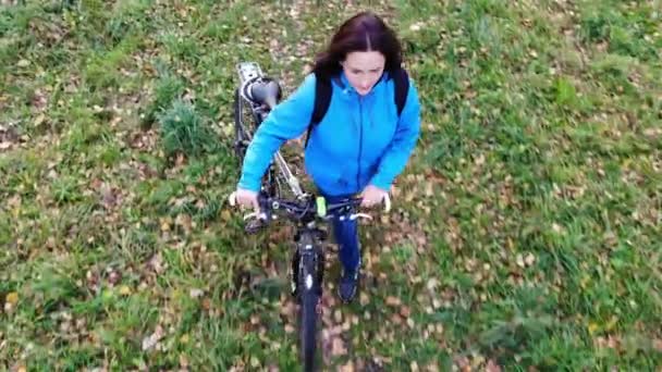 Volar sobre la mujer con bicicleta caminando en el parque de otoño, despreocupado y feliz, concepto inspirador — Vídeos de Stock