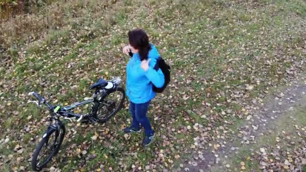 Se préparer pour l'aventure, belle femme portant un sac à dos, assis ob vélo, et obtenir tour dans — Video