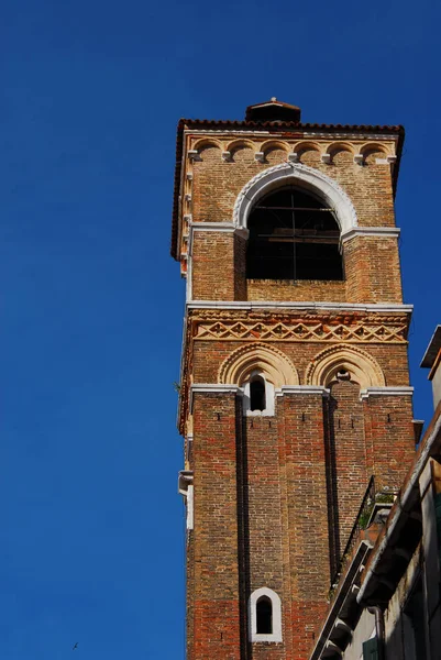 Medieval bell tower of St John the Almsgiver Church in the historic center of Venice, erected in the 14th century (with copy space)