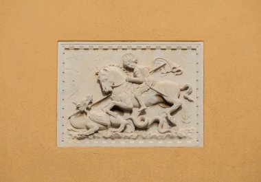 Saint George fights and kill the evil Dragon old relief on a Venice wall clipart
