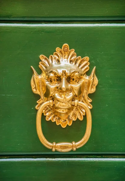 Grotesque golden door clapper in the shape of a Demon or Goblin