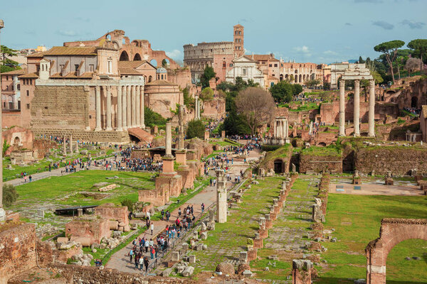 Rome, ITALY, APRIL 10, 2018 - Sightseeing in Rome. Tourists visit Roman Forum ancient ruins